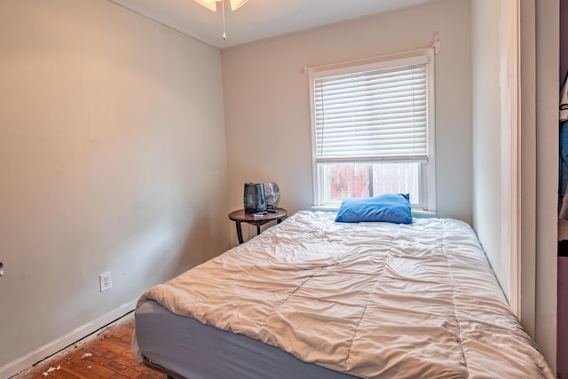 bedroom featuring wood finished floors and baseboards
