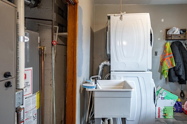 laundry area featuring gas water heater and estacked washer and dryer