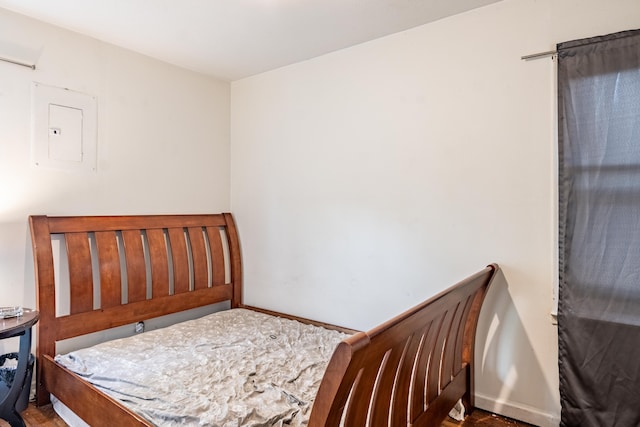 bedroom with electric panel and baseboards