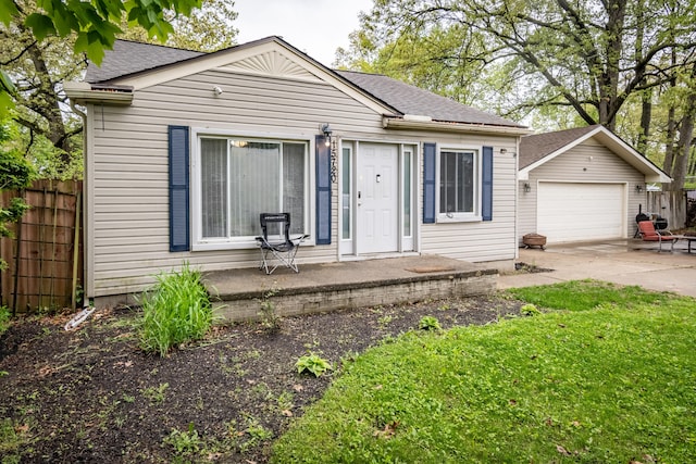 view of front of house with a garage and a shingled roof