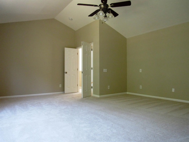 unfurnished room with a ceiling fan, lofted ceiling, light colored carpet, and baseboards