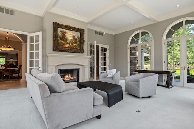 230 Corrie Rd, Ann Arbor, MI 48105 - carpeted living room with french doors, plenty of natural light, a glass covered fireplace, ornamental molding, and beamed ceiling