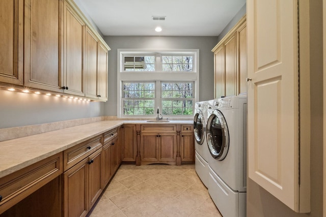 230 Corrie Rd, Ann Arbor, MI 48105 - laundry room with cabinet space, washer and clothes dryer, light tile patterned flooring, and recessed lighting