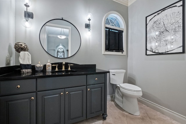 230 Corrie Rd, Ann Arbor, MI 48105 - bathroom with baseboards, crown molding, toilet, vanity, and tile patterned floors