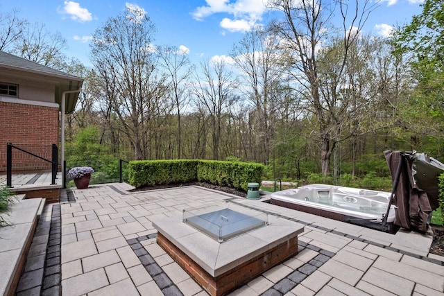230 Corrie Rd, Ann Arbor, MI 48105 - view of patio / terrace featuring an outdoor hot tub and a wooded view
