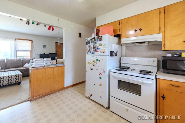 2324-2326 38th St SW, Wyoming, MI 49519 - kitchen featuring white appliances, under cabinet range hood, light flooring, an office area, and light countertops
