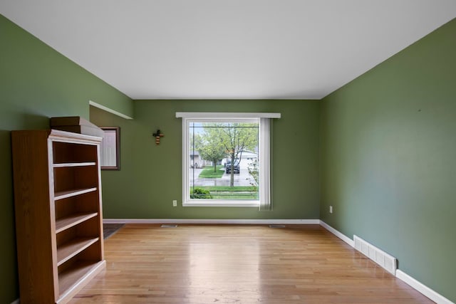 empty room with light wood-type flooring and baseboards