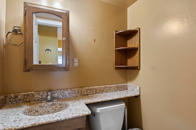 bathroom featuring toilet and vanity
