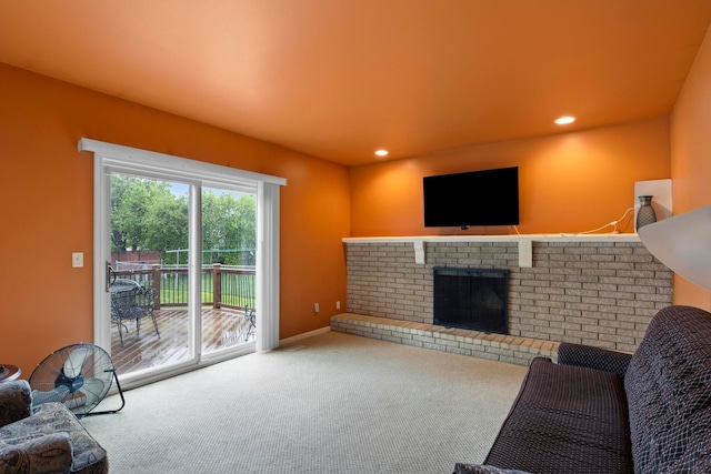 carpeted living area with a brick fireplace and recessed lighting