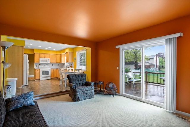 carpeted living room with baseboards and recessed lighting