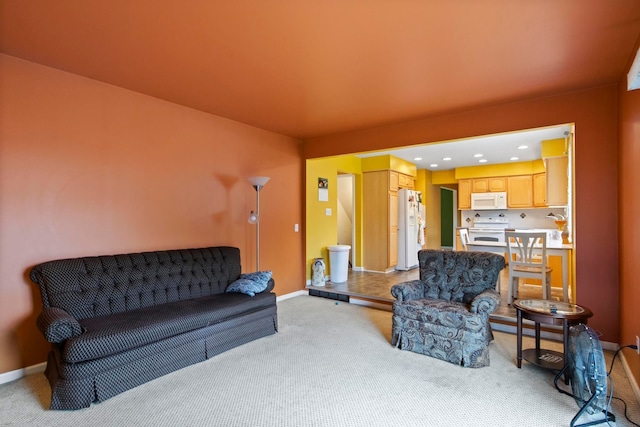 living area with light carpet and baseboards