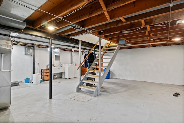 unfinished below grade area featuring washer and clothes dryer and stairway