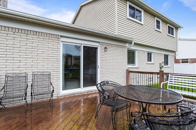 wooden deck featuring outdoor dining space