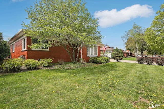 2330 Ashby St, Trenton, MI 48183 - view of front of home with an attached garage, a front yard, brick siding, and concrete driveway