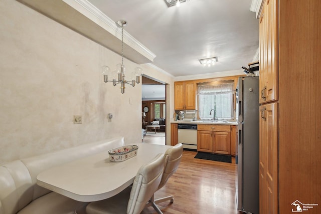 2330 Ashby St, Trenton, MI 48183 - dining space with ornamental molding, a chandelier, and light wood finished floors