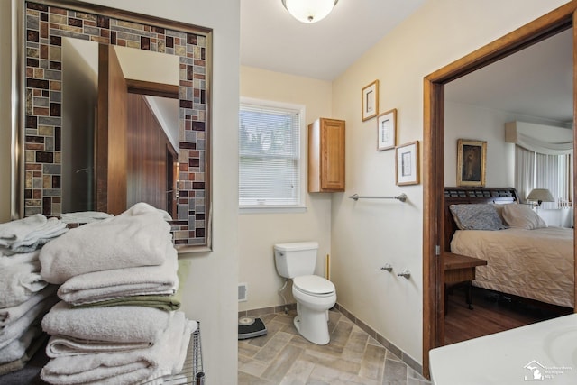 2330 Ashby St, Trenton, MI 48183 - ensuite bathroom featuring toilet and baseboards