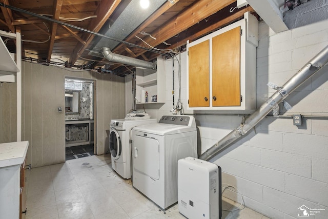 2330 Ashby St, Trenton, MI 48183 - laundry area featuring cabinet space, washer and clothes dryer, and concrete block wall