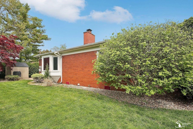 2330 Ashby St, Trenton, MI 48183 - view of home's exterior featuring a chimney, a lawn, brick siding, an outdoor structure, and a storage shed