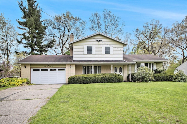 traditional home with a garage, asphalt driveway, a front yard, a chimney, and brick siding