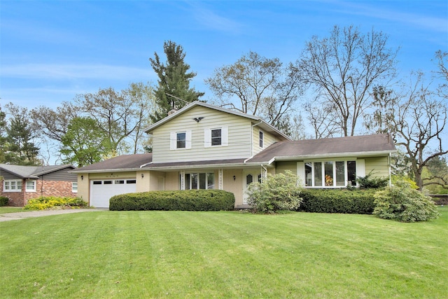 view of front of house featuring an attached garage and a front lawn