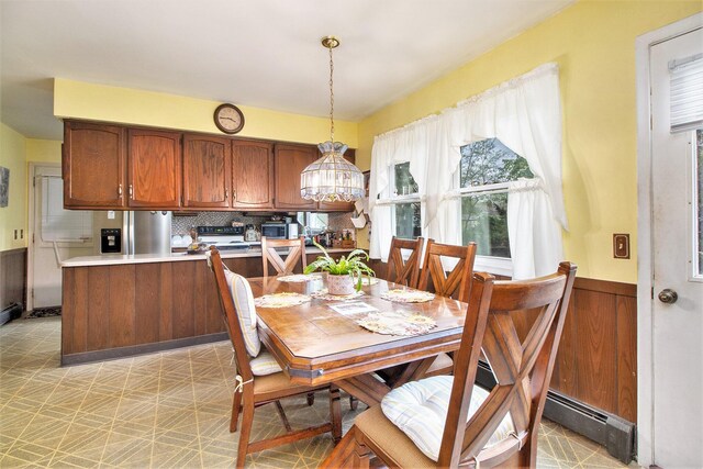 dining area with light floors and a chandelier
