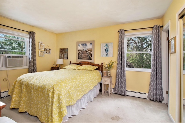 carpeted bedroom with a baseboard heating unit and cooling unit