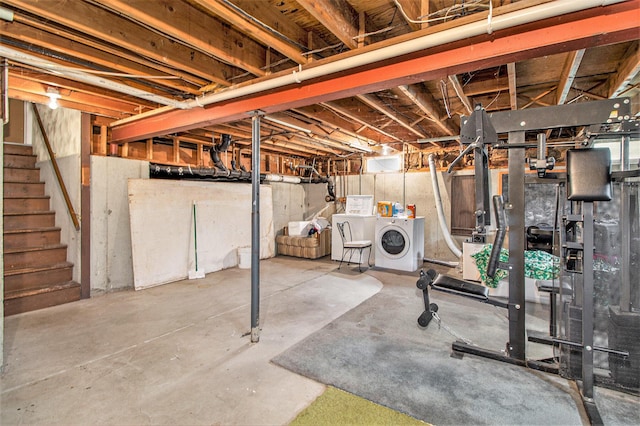 unfinished basement featuring washing machine and dryer and stairway