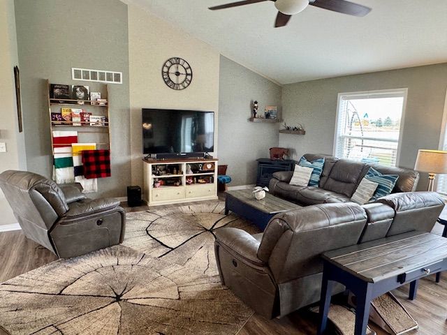 2660 Bay Pt, Imlay City, MI 48444 - living room with vaulted ceiling, a ceiling fan, wood finished floors, and baseboards