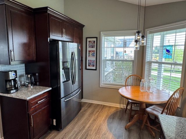 2660 Bay Pt, Imlay City, MI 48444 - kitchen featuring stainless steel fridge, baseboards, light wood finished floors, tasteful backsplash, and dark brown cabinets