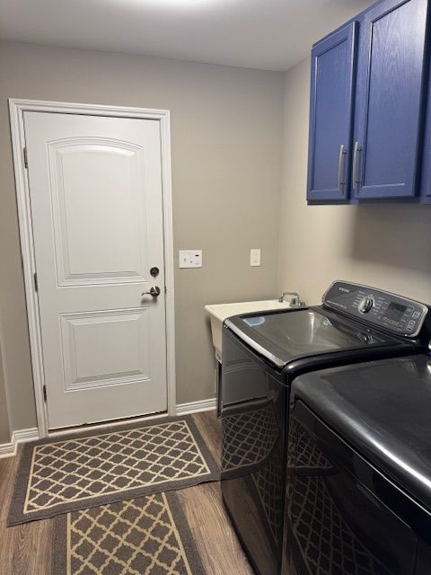 2660 Bay Pt, Imlay City, MI 48444 - washroom with washer and clothes dryer, dark wood-type flooring, cabinet space, and baseboards