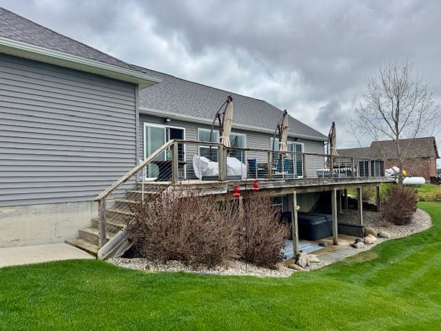 2660 Bay Pt, Imlay City, MI 48444 - back of property with a hot tub, a deck, a yard, and roof with shingles