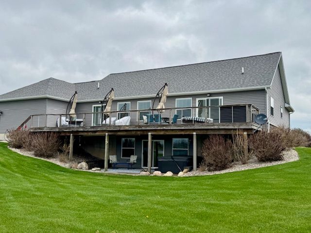 2660 Bay Pt, Imlay City, MI 48444 - rear view of house featuring a deck, a lawn, and a shingled roof