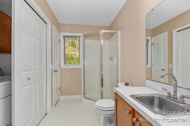 1854 Pinehill Dr, Hastings, MI 49058 - full bath with washer / clothes dryer, a stall shower, vanity, toilet, and baseboards