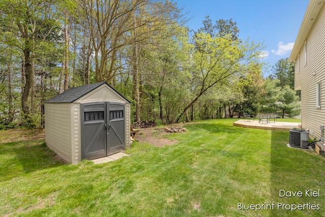 1854 Pinehill Dr, Hastings, MI 49058 - view of grassy yard with a storage unit, an outbuilding, central AC, and a patio