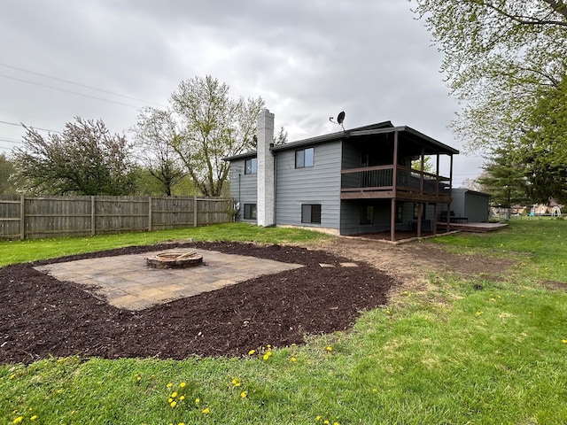 back of property featuring an outdoor fire pit, a patio area, a chimney, and a deck