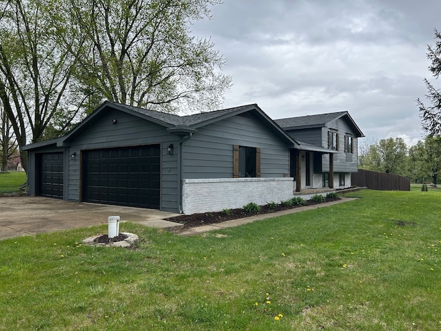 view of side of property with brick siding, a lawn, and a garage