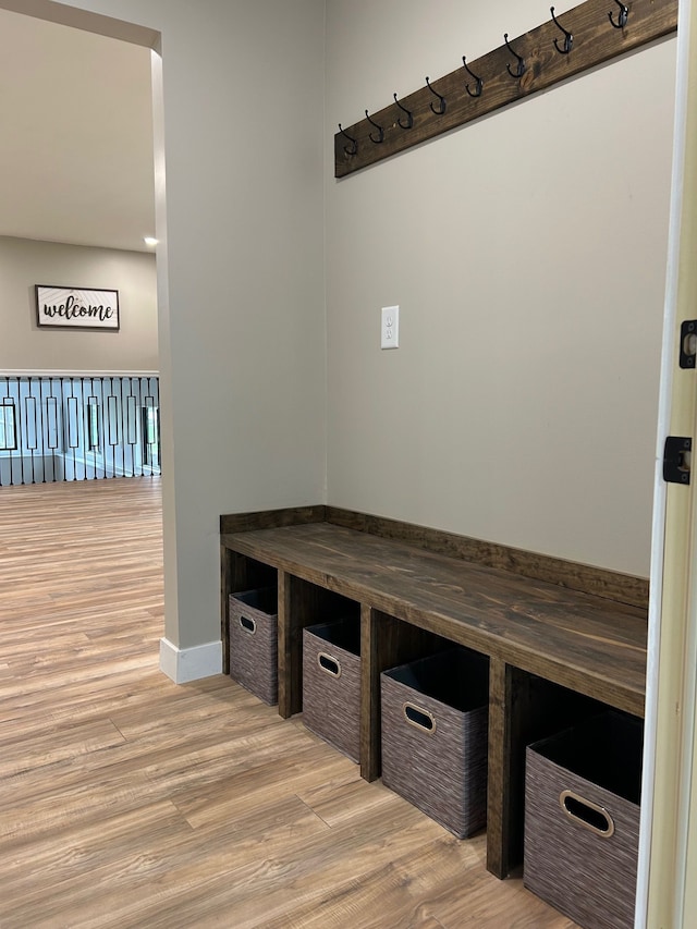 mudroom featuring wood finished floors and baseboards