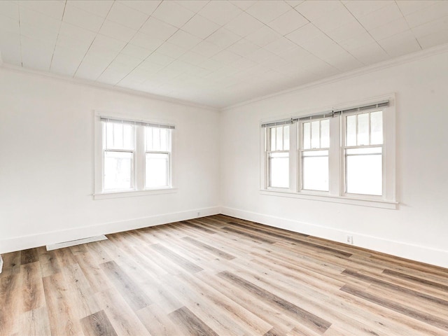 1308 10th St, Port Huron, MI 48060 - empty room with ornamental molding, healthy amount of natural light, wood finished floors, and baseboards
