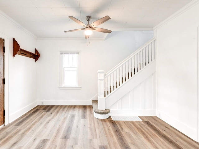 1308 10th St, Port Huron, MI 48060 - unfurnished living room with crown molding, stairway, wood finished floors, ceiling fan, and baseboards