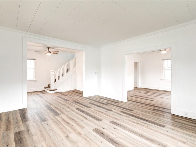 1308 10th St, Port Huron, MI 48060 - unfurnished living room featuring crown molding, stairs, light wood-style floors, and a ceiling fan