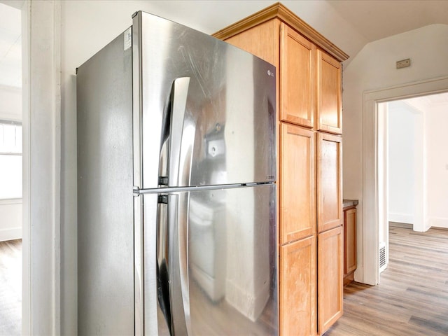 1308 10th St, Port Huron, MI 48060 - kitchen with freestanding refrigerator, light wood-type flooring, and lofted ceiling