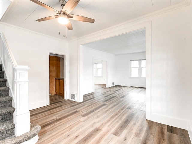 1308 10th St, Port Huron, MI 48060 - unfurnished living room featuring stairway, wood finished floors, ceiling fan, ornamental molding, and baseboards