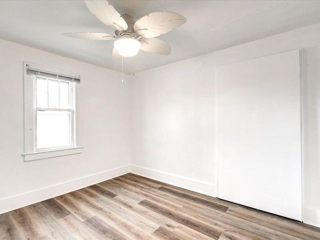 1308 10th St, Port Huron, MI 48060 - empty room featuring light wood-type flooring, baseboards, and a ceiling fan
