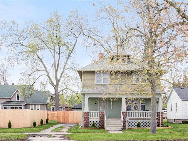 1308 10th St, Port Huron, MI 48060 - american foursquare style home featuring a porch and a chimney