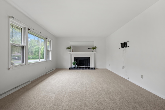 unfurnished living room with a baseboard heating unit, a fireplace, carpet, and baseboards