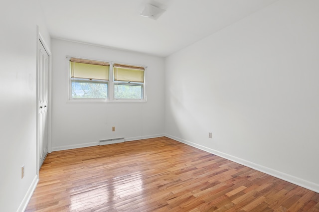 empty room with light wood-style floors and baseboards