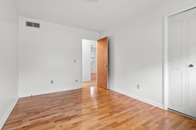 unfurnished bedroom featuring light wood-type flooring and baseboards