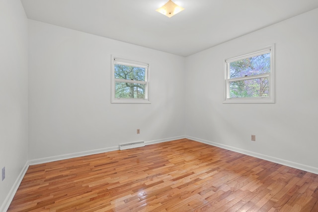 empty room with light wood-style floors and baseboards