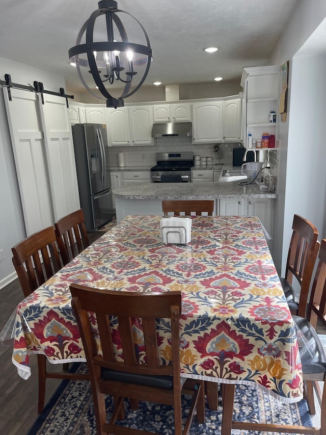 945 Valley Ave, Fremont, MI 49412 - dining area with a barn door, a chandelier, recessed lighting, and dark wood-style floors