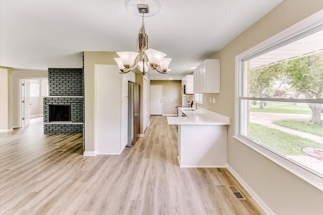 2365 Middlebelt Rd, West Bloomfield, MI 48324 - kitchen with a sink, baseboards, light countertops, and white cabinets
